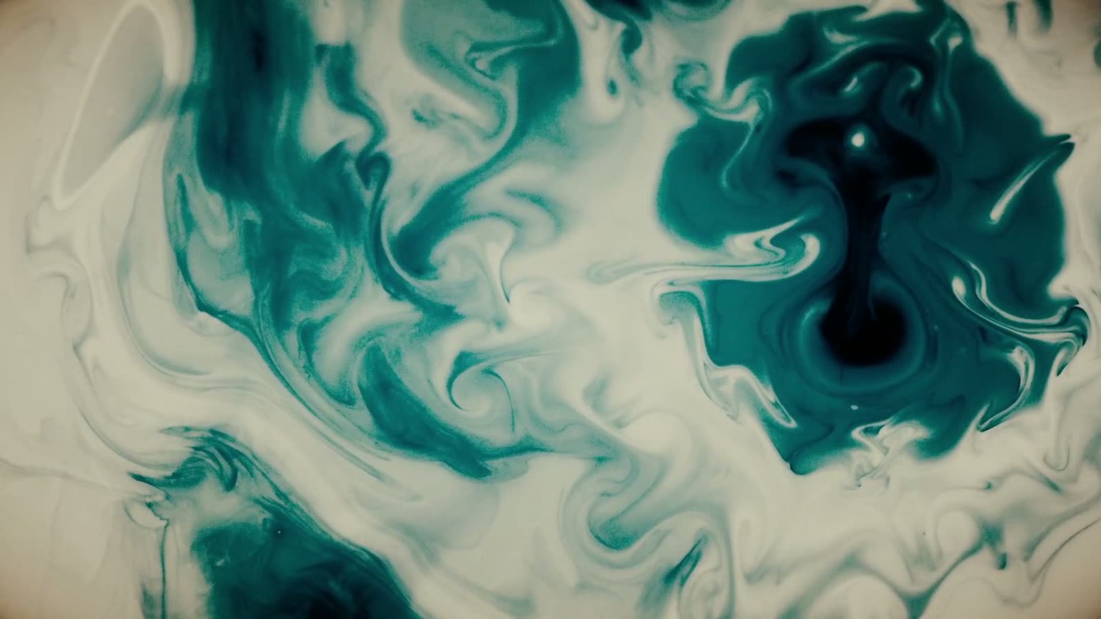 Deep teal ink blooming through water, from a House of Berseri acrylic pour study